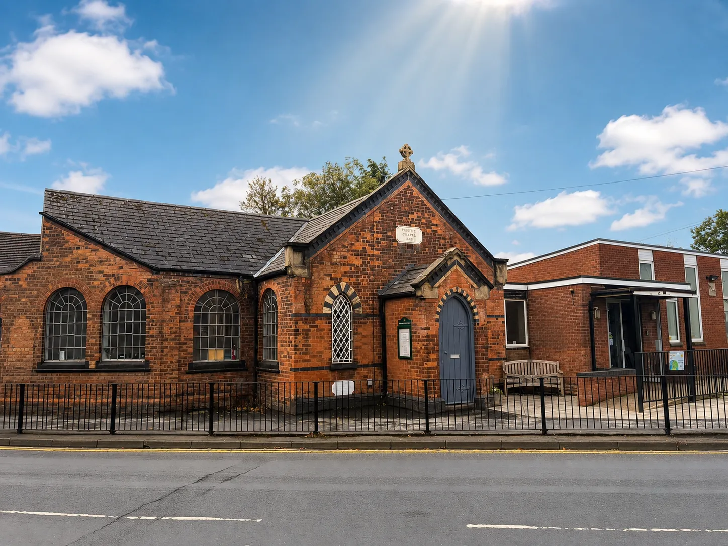 The full exterior of Water Orton Methodist Church and Centre from across the street, showing the chapel and the modern extension side by side