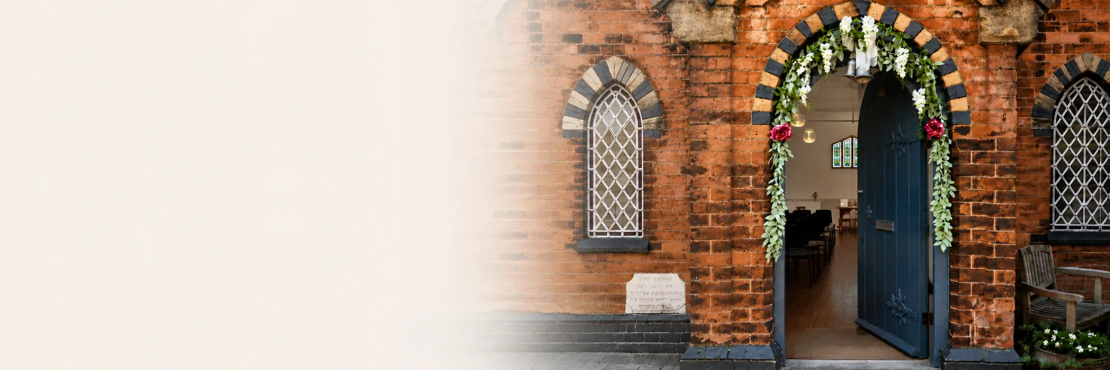 The open blue entrance door of Water Orton Methodist Church, framed by an arched brick doorway
