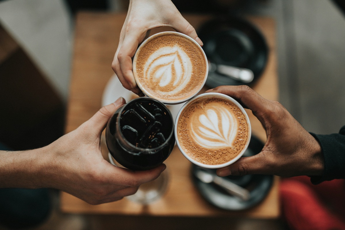 Friends sharing drinks together at a community coffee morning